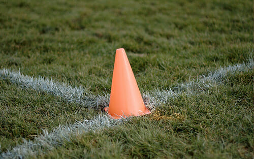 An orange cone marking the corner of an endzone.