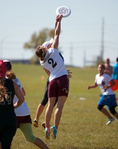 Players from Heist and Pop battle for a disc in the air at North Central Regionals