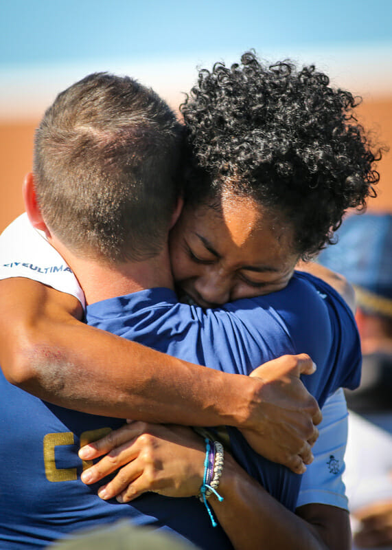 Scandal coach Alex Ghesquiere and captain Octavia 'Opi' Payne embrace after winning the 2013 Club Championships.