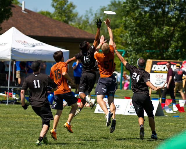 Texas' Will Driscoll goes up between a pair of UNC defenders at the 2014 College Championships.