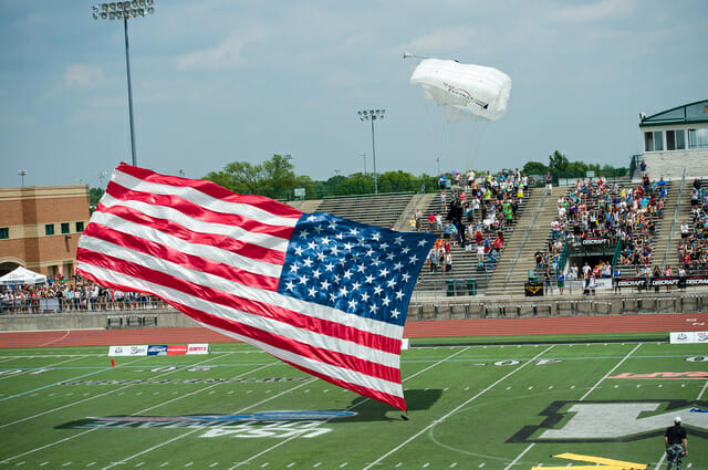 A skydiver lands on the field at the 2014 College Championships.