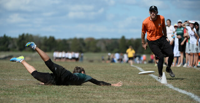 Observer watches as a player dives for a disc.